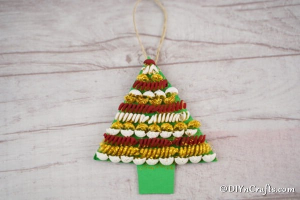 A simple pasta christmas tree laying on a wooden table