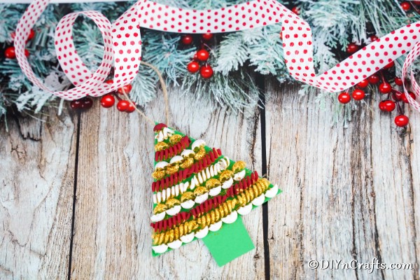 A christmas decoration pasta tree laying on a wooden surface