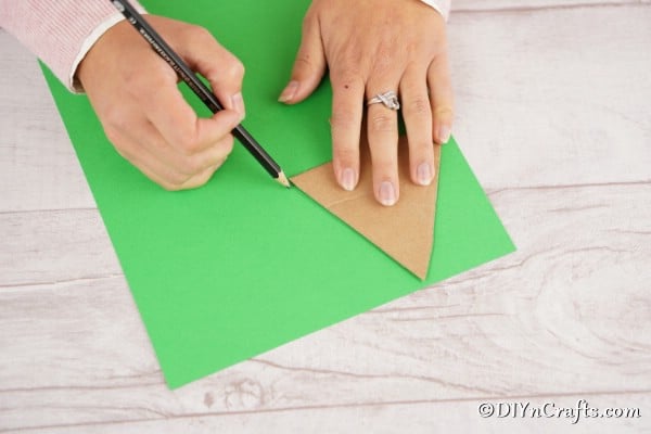 Cutting out a cardboard tree for the christmas tree craft