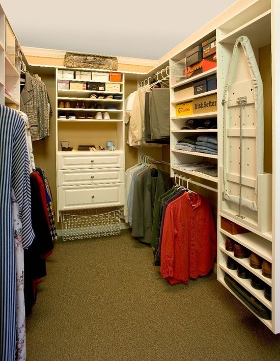 Master walk in closet featuring a ironing board