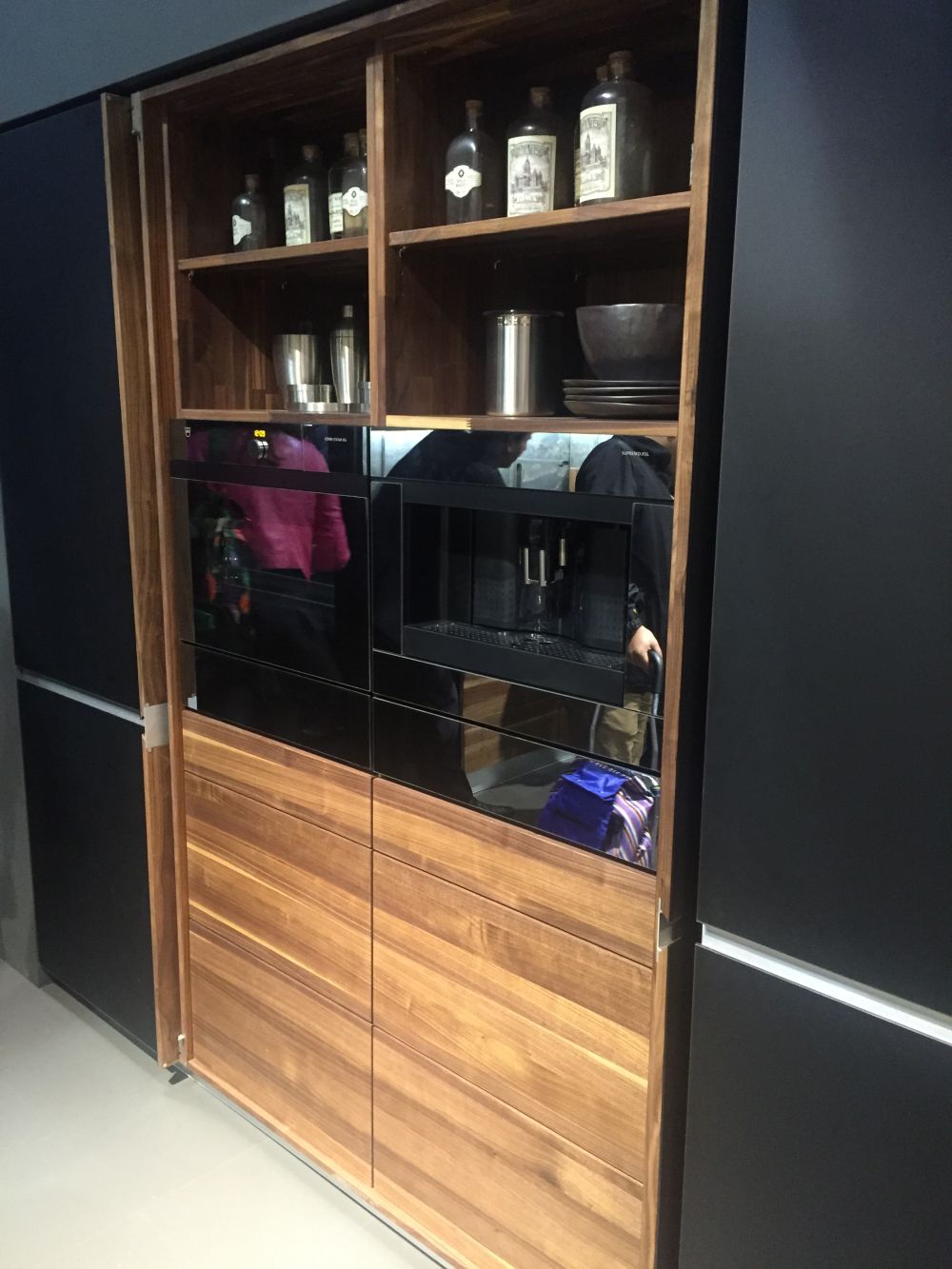 Black kitchen with pocket doors that help to hide appliances