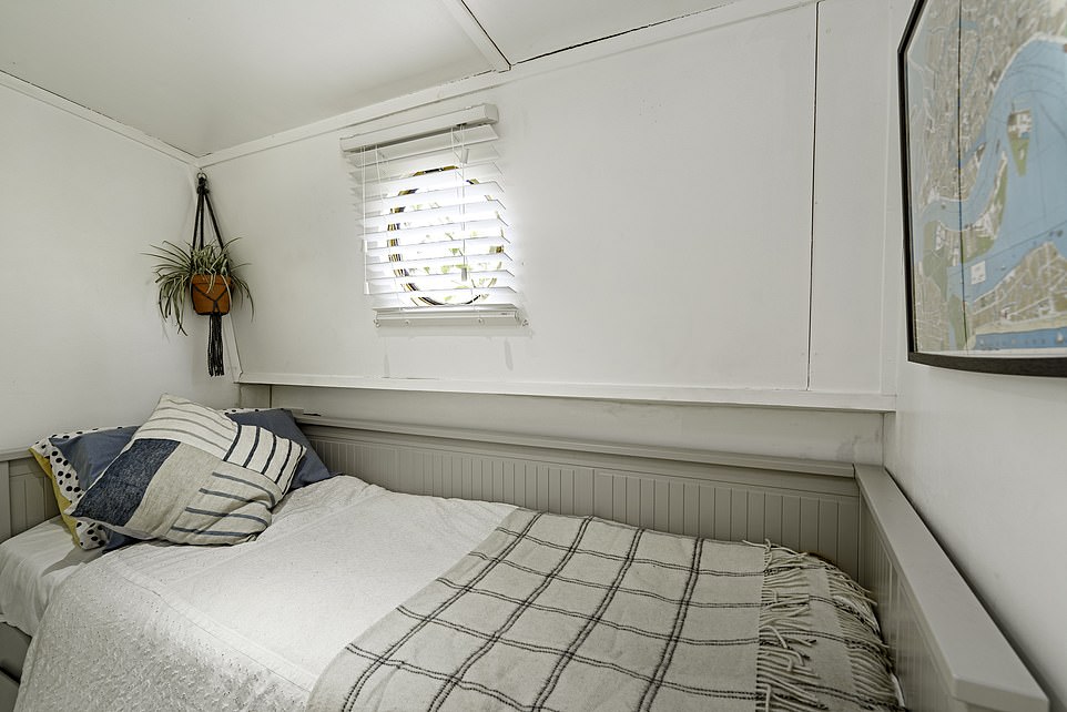 The smaller bedroom has a quaint port hole, complete with a small blind for privacy, and fits a single bed inside