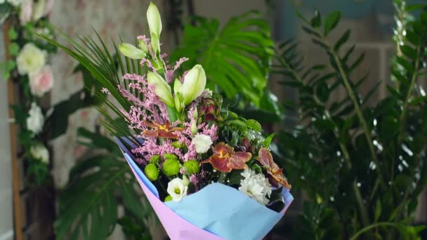 Divine beauty.Flower bouquet in the rays of light, rotation, consists of Orchid vanda, Chrysanthemum bacardi, solidago, Eustoma, Alstroemeria, Santini , gypsophila, Russus , Phoenix robbeli, Amaryllis Royalty Free Stock Video