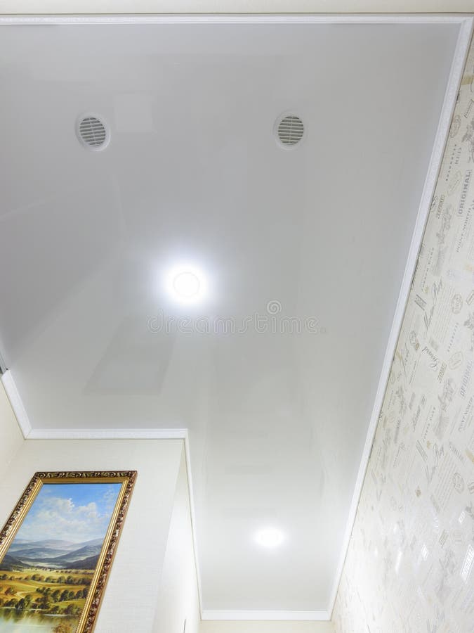 Anapa, Russia - June 25, 2020: Stretch glossy ceiling with spotlights and ventilation outlets in a long small corridor stock photos