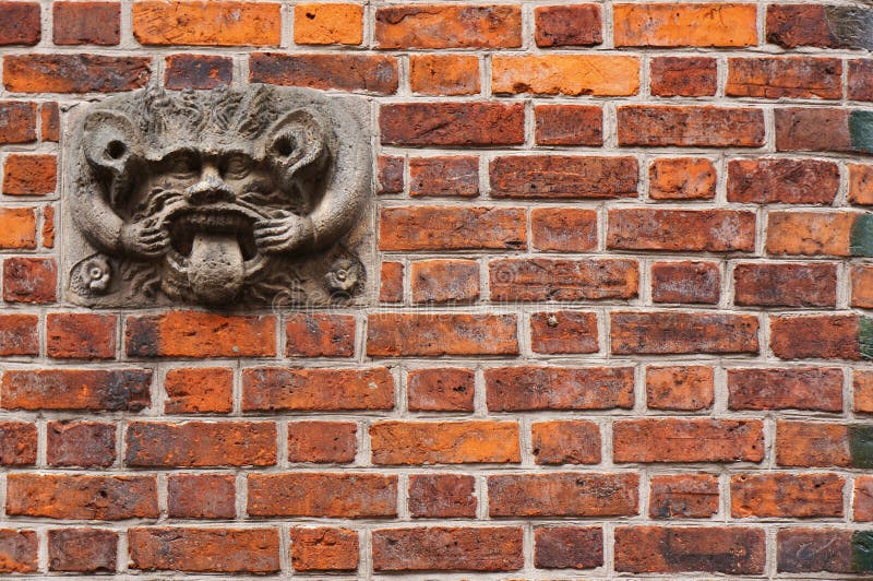 Ancient sculpture of devil on wall of Old Town Hall in Hannover, Germany. royalty free stock photography