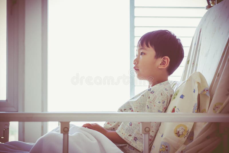 Asian child admitted at hospital room with infusion pump intrave. Illness asian child admitted at modern and comfortable equipped hospital room. Health care and stock photography