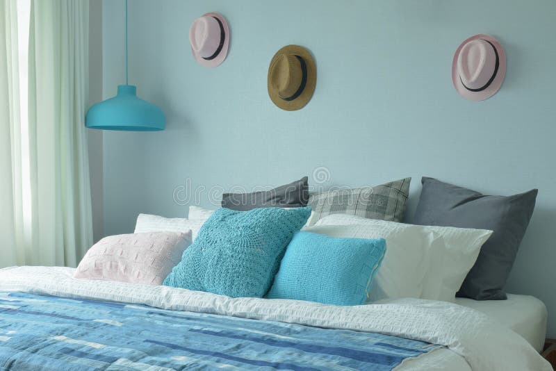 Blue color scheme teenager bedroom with hats on wall. Decoration stock photography