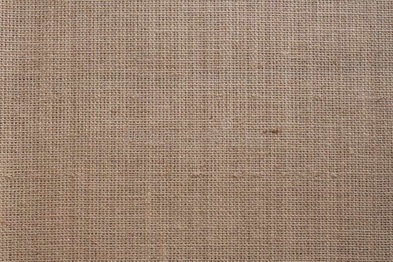 Brown rough burlap texture. Texture of brown rough burlap or fabric of sack as a background stock image