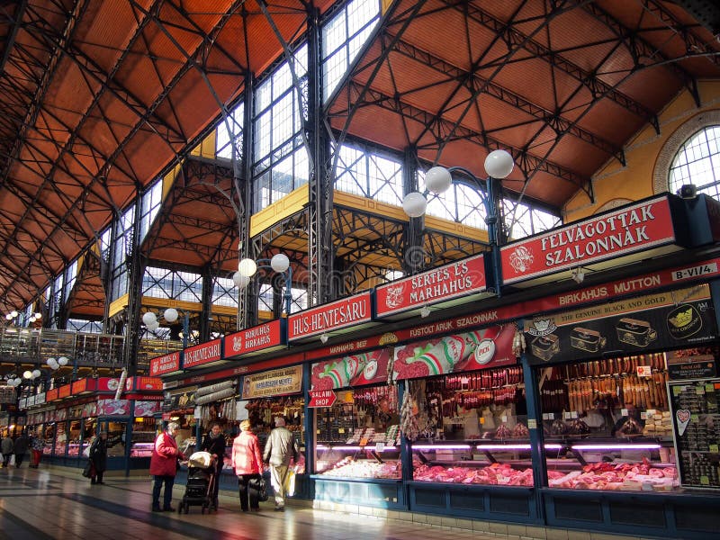 People shopping in the Great Market Hall in the section dedicated to butchers and meat produce stock photography