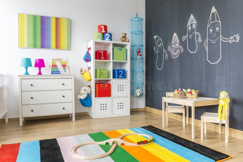 Child room with colorful rug. View of child room with colorful rug and blackboard wall royalty free stock images
