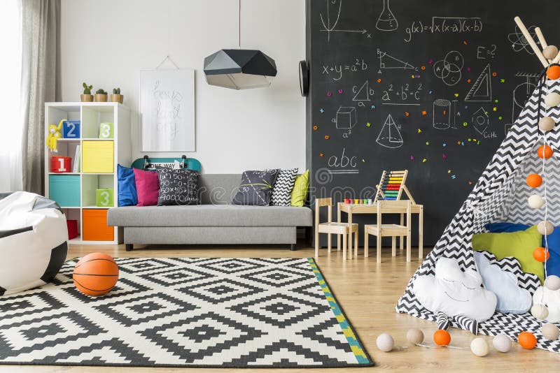 Child room ideal to sleep and play. Spacious black and white child room with window, sack chair, regale, sofa, carpet, chalkboard wall, small table, chairs and stock photos