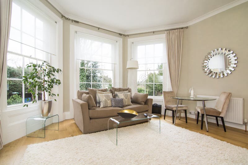 Classic living room with large bay window facing lovely garden stock photography