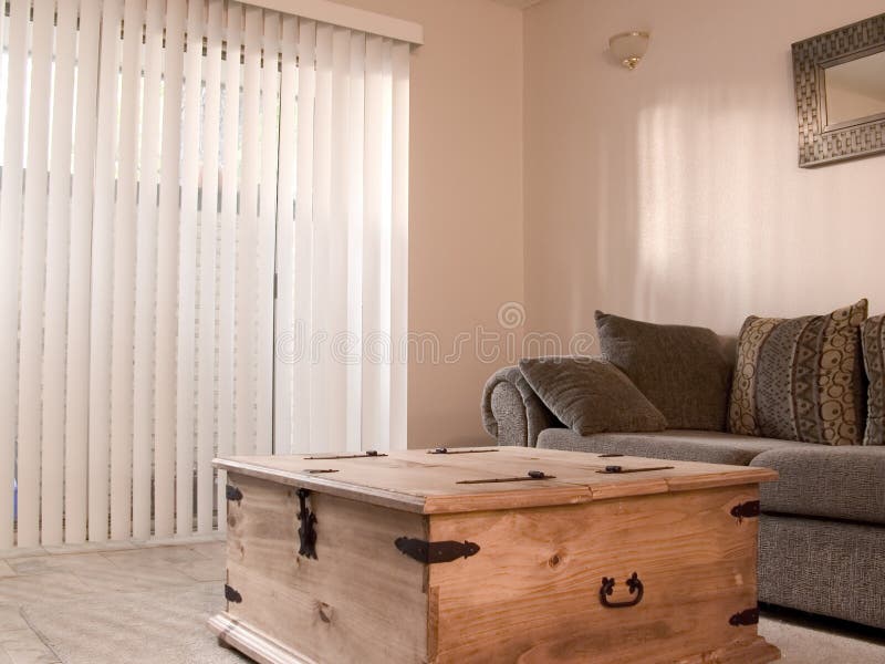 Cozy room with vertical blinds. A cozy living or family room with vertical blinds royalty free stock images