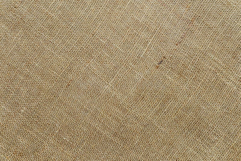 Diagonal burlap texture of natural color. Sackcloth rustic canvas background. Rough fabric woven of flax, jute or hemp. Design. Element. Top view stock photography