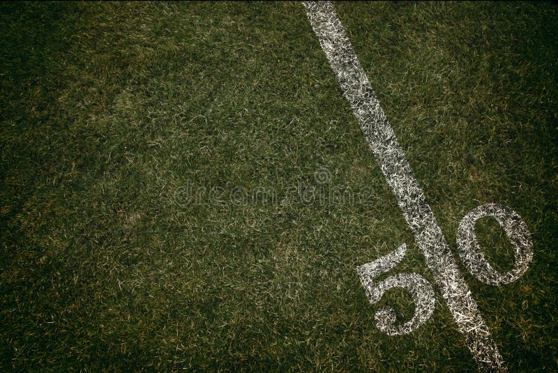 Football field ground fifty yard line. Friday night lights. Looking down from above stock photo