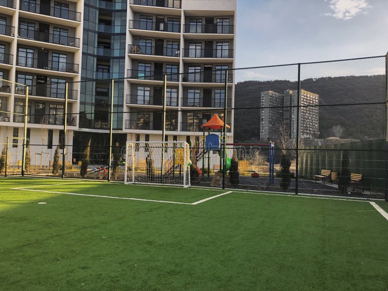 Football gates to the sports ground in the city yard on the background of a new residential building.  royalty free stock photography