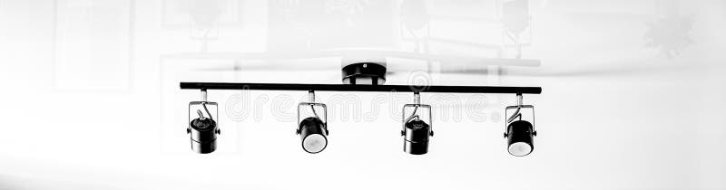 A fragment of the interior of the home loft lighting. Abstract lamp in the form of a soffit in daylight. stock images