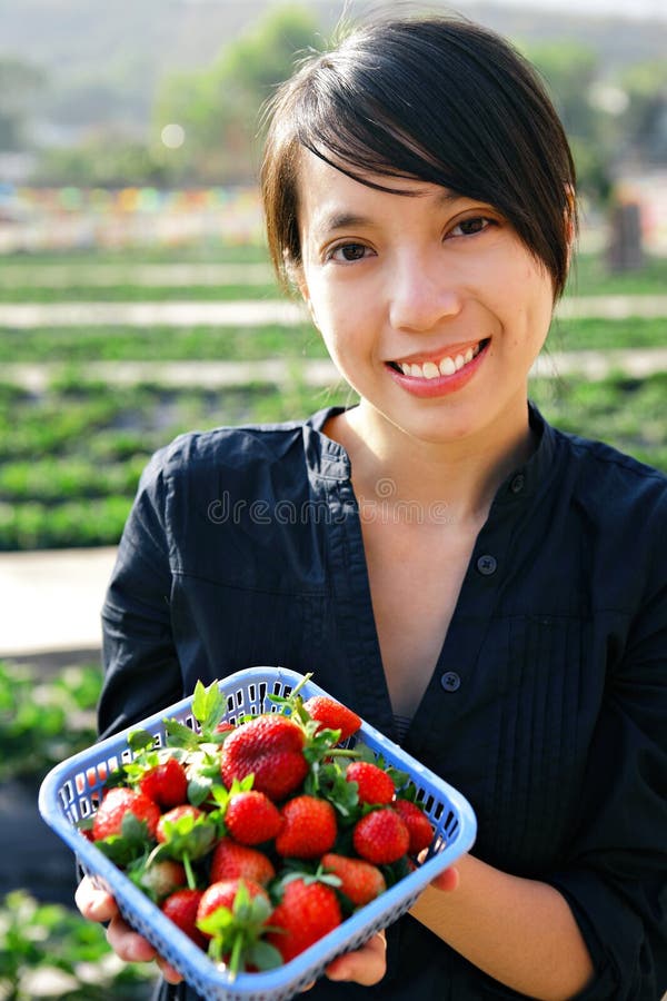 Girl showing strawberry stock image