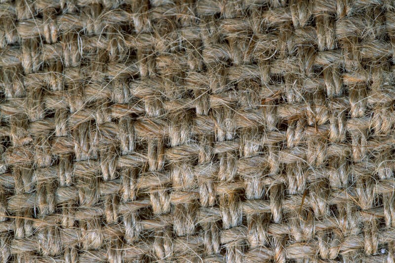 Grey burlap fabric closeup photo. Rough texture of natural burlap. Grunge textile for sack. Hemp or grass woven fabric. Grey burlap fabric closeup photo. Rough royalty free stock image