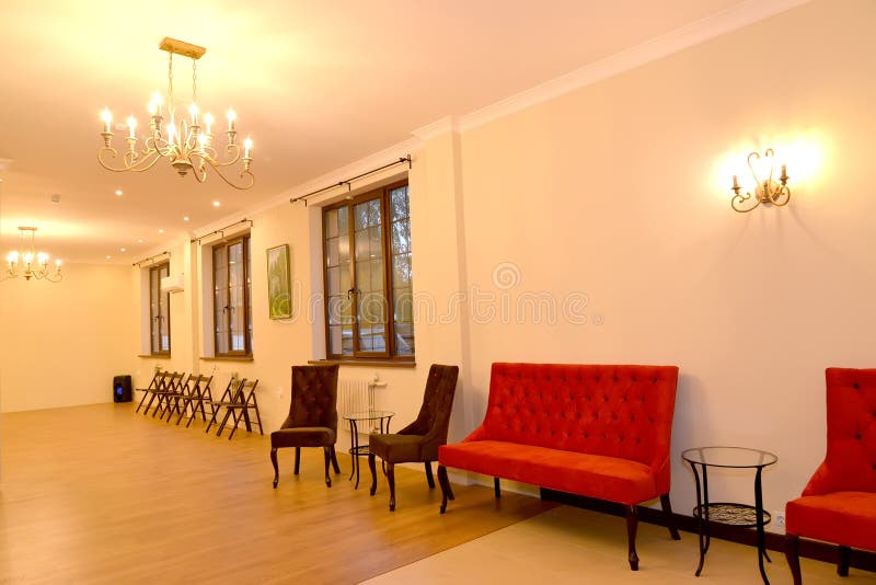 Hall interior with upholstered furniture along a wall.  stock photo