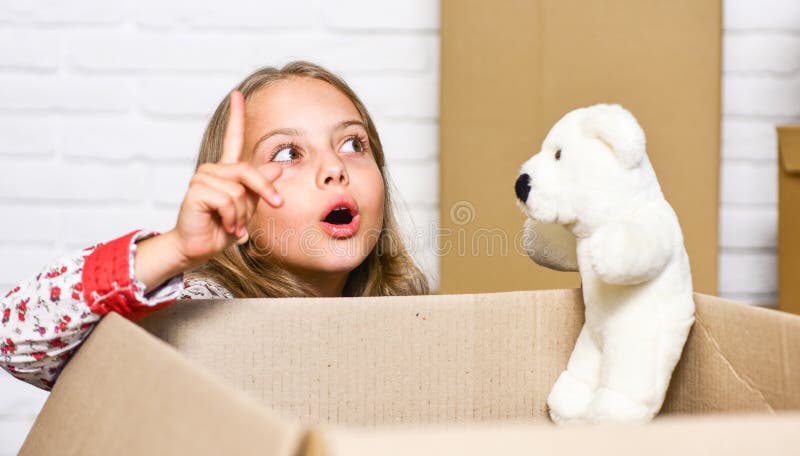 I have an idea. happy child cardboard box. happy little girl with toy. repair of room. new apartment. Cardboard boxes -. Moving to new house. purchase of new royalty free stock photo