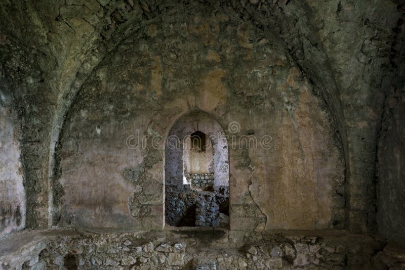 Interior of ruined hall with cracked, damaged walls and corridor in the St Hilarion ancient castle, Kyrenia stock photo