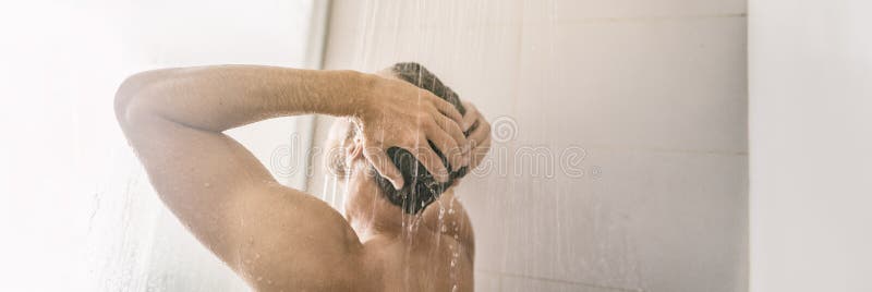 Morning shower young man showering taking a hot bath washing hair panorama banner home lifestyle background.  royalty free stock images