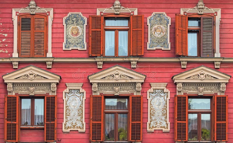 The most beautiful facade in Rotovz Town Hall Square in Maribor. Six windows with wooden shutters. The wall decorated by paintings. Maribor, Slovenia stock photography