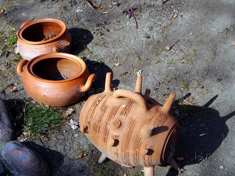 Old clay broken pottery on the ground in the yard of a roadside restaurant. Performs decorative functions royalty free stock photography