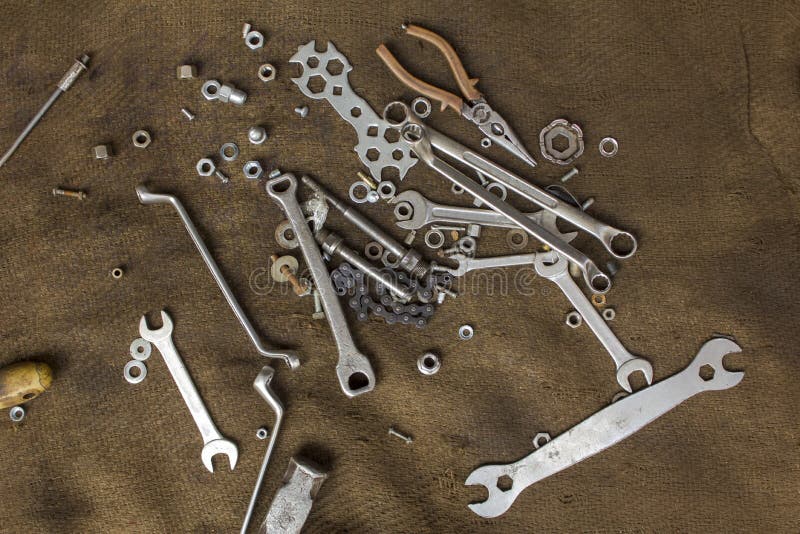 Old metal tools and screw-nuts on a dirty burlap close-up. rough surface texture. A old metal tools and screw-nuts on a dirty burlap close-up. rough surface stock images