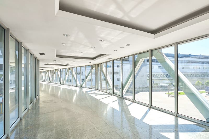 Panoramic view on empty office hall with glass wall windows. made of metal and glass. Modern corridor metal and glass construction. Commercial architecture stock photo