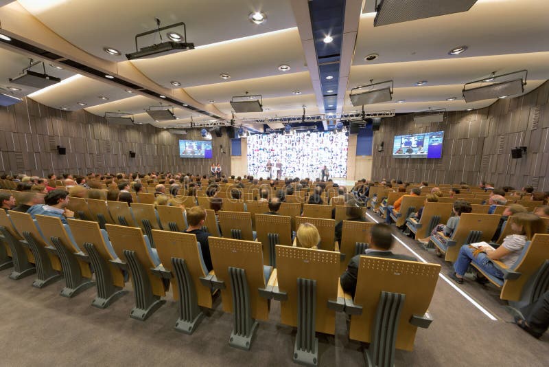 People in main conference hall stock image