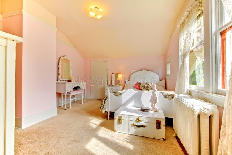 Pink bedroom with white bed and nightstand royalty free stock photography