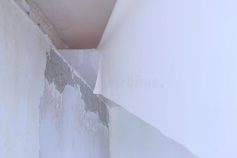 Process of dismantling of stretch suspended ceiling in flat, closeup view. royalty free stock images
