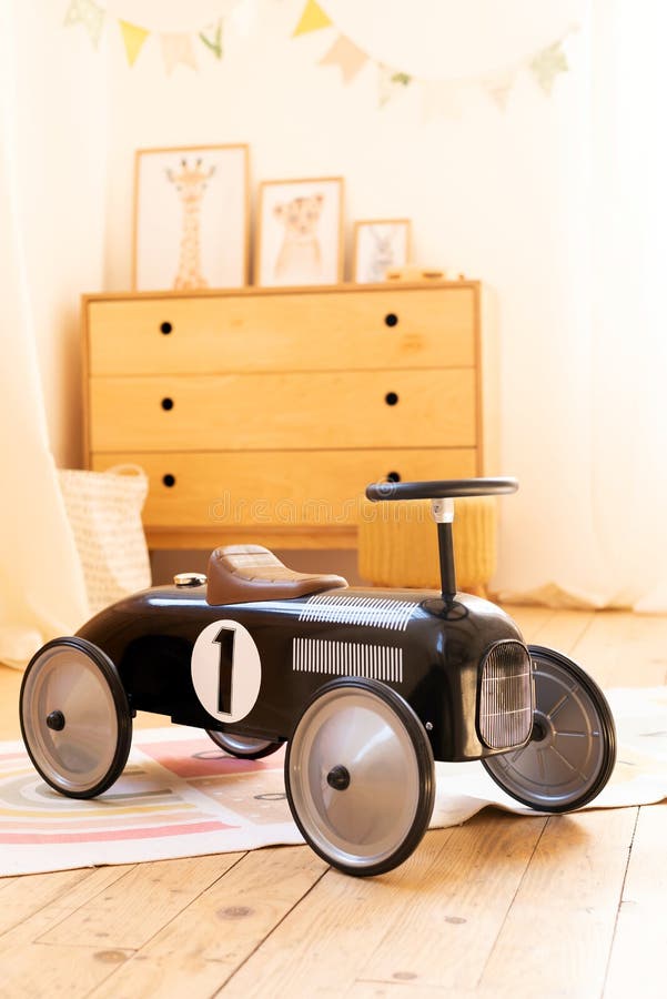 Retro style children`s racing car in a children room. Black vintage model of race car for boy. interior children bedroom stock photography
