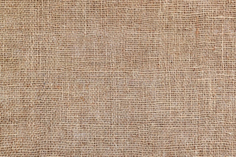Rural texture of sackcloth. Background of very coarse, rough fabric woven made of flax, jute or hemp. Burlap bag material. Design. Element. Sacking and bagging royalty free stock photo