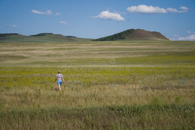 Single woman in steppe royalty free stock photo