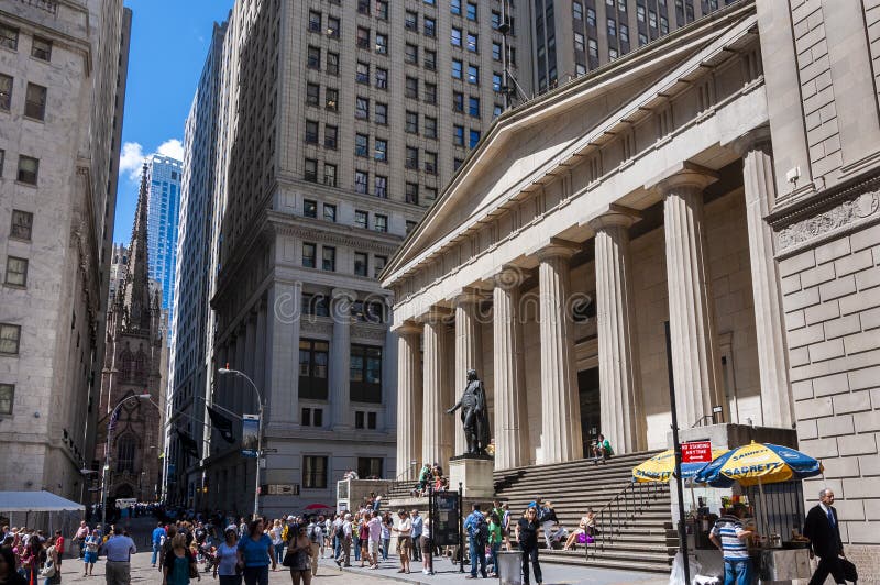 Street scene with people in front of the Federal Hall in Wall Street, New York City. New York City, USA - June 7, 2010: Street scene with people in front of the royalty free stock images