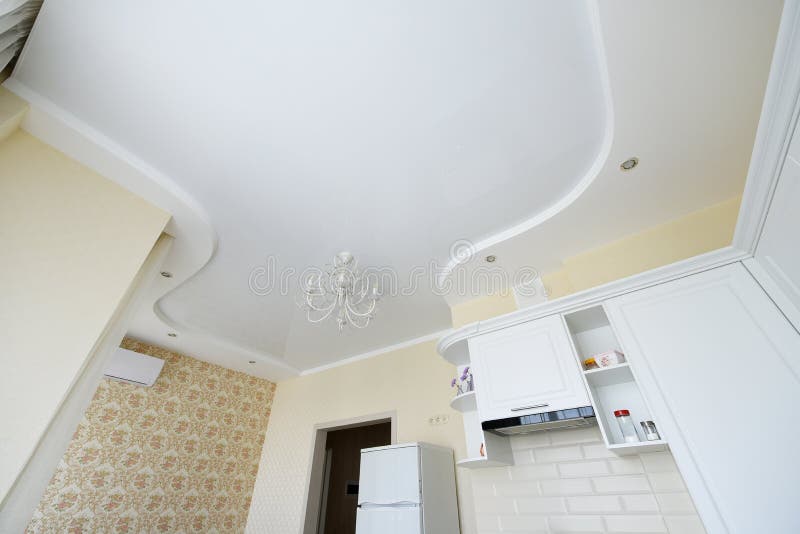 Stretch ceiling in the kitchen. Stretch ceiling white and complex shape stock photos