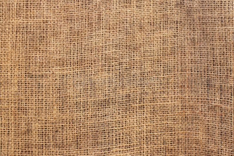The texture of the material with a rough weaving of linen fibers of brown color. Burlap for decoration and design of web page and. Interior. Manual homework royalty free stock photography