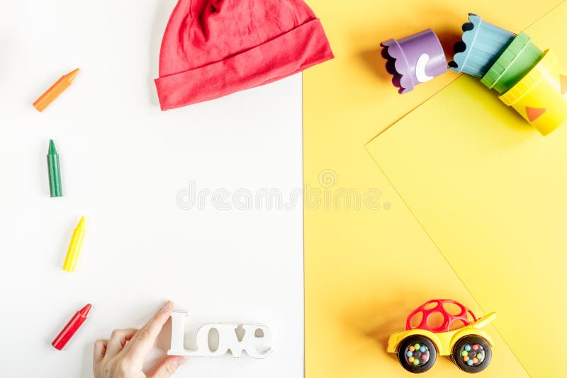 Toys and clothes collection for child room top view mockup. Toys and clothes collection for child room on white and yellow table background top view mockup stock images