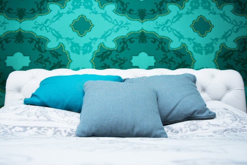 Turquoise blue and white bedroom. Bedroom design with colorful wallpaper and turquoise and white color royalty free stock images