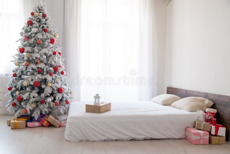 White Christmas tree with red bedroom toys new year winter gifts decor. White Christmas tree with red bedroom toys new year winter gifts royalty free stock photography