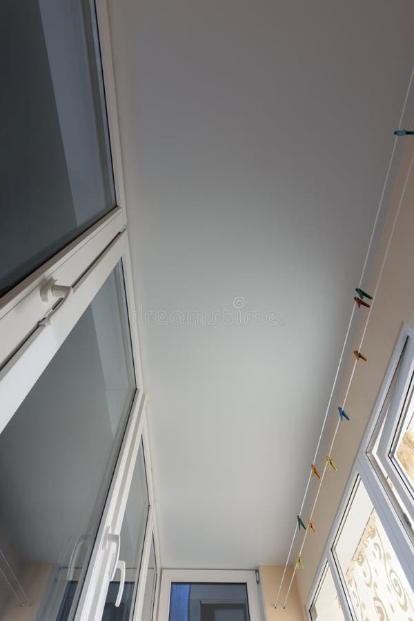 White matte stretch ceiling on the balcony stock images