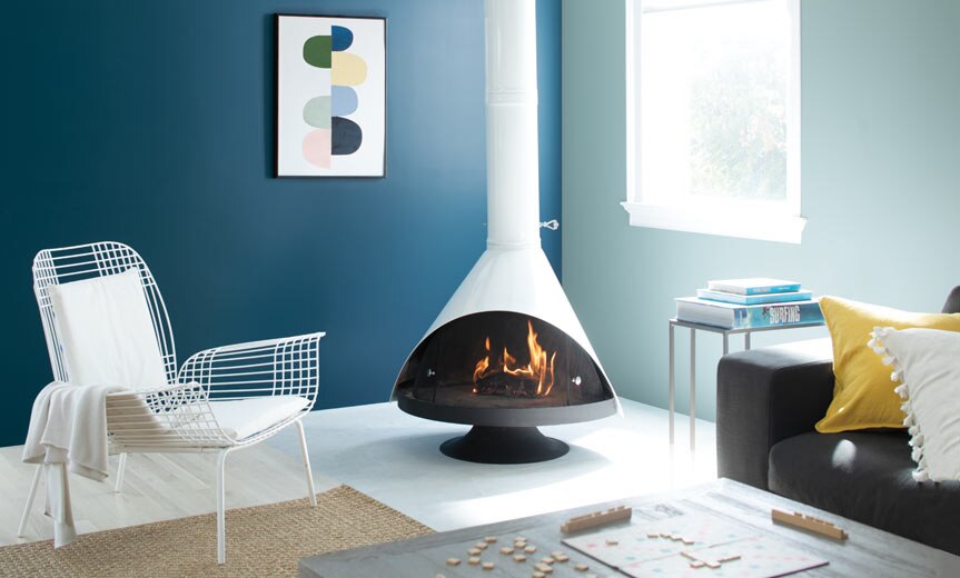 A cozy living room complete with a retro fireplace accompanied by blue painted walls