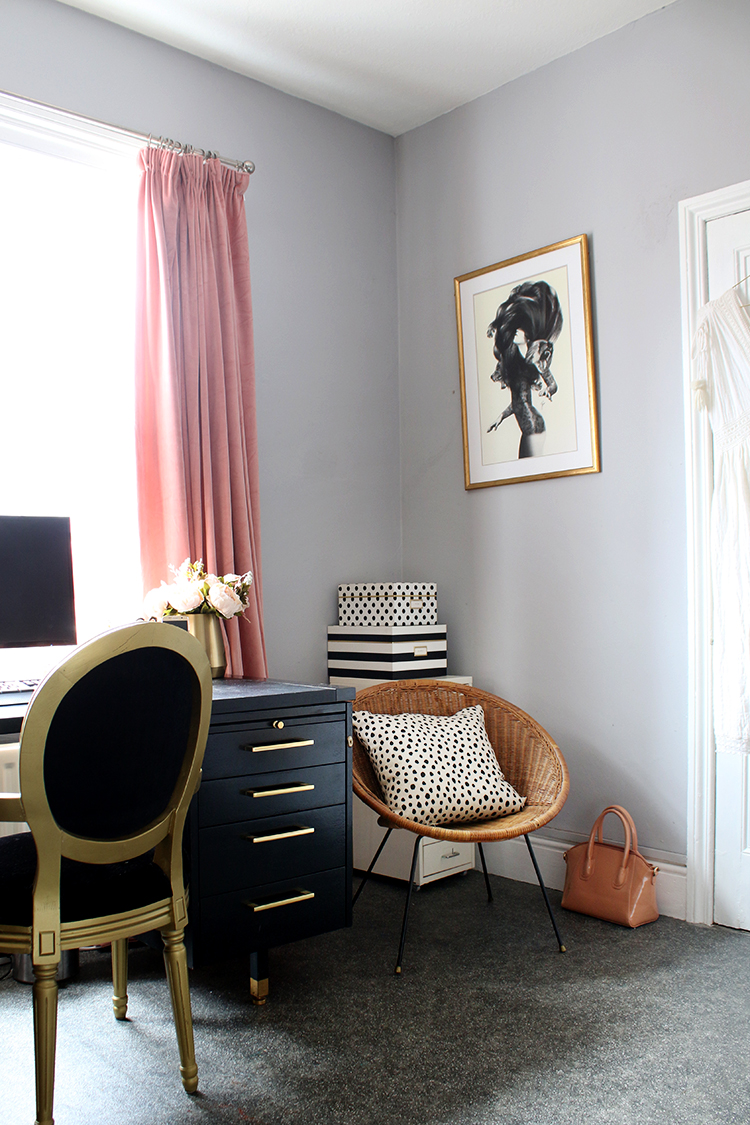 corner of home office with black gold and pink accessories